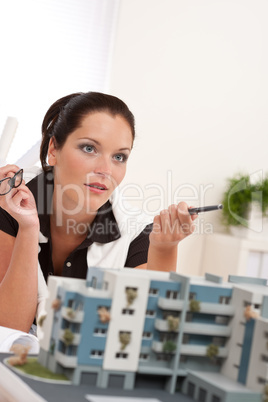 Portrait of female architect with architectural model