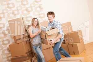 Moving house: Young couple with box