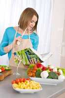 Cooking - Woman reading cookbook in kitchen