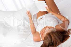 White lounge - Woman reading white book