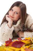 Autumn portrait of beautiful woman with leaf wearing turtleneck