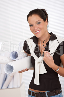 Smiling female architect holding plans and glasses