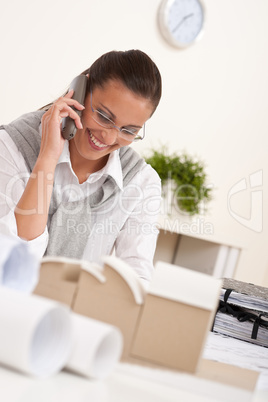 Young female architect with phone