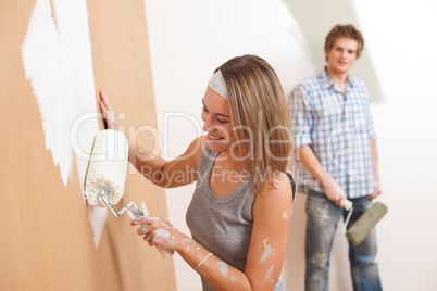 Home improvement: Young man and woman painting wall