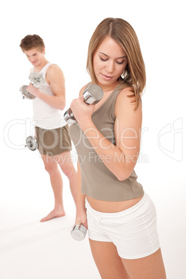 Fitness - Young couple training lifting weights on white