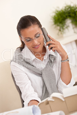 Young female architect with phone