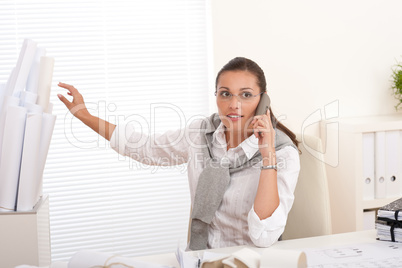 Young female architect with phone