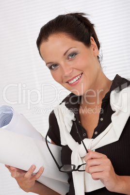 Smiling female architect with plans