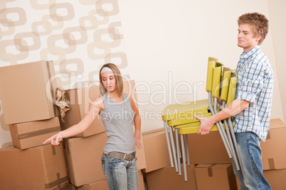 Moving house: Man and woman with box and chair