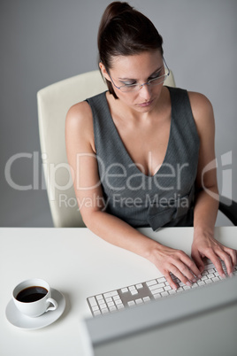 Successful business woman at office having coffee