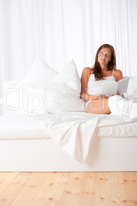 White lounge - Brown hair woman sitting on white sofa