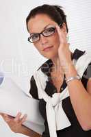 Female architect holding plans and glasses