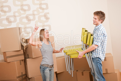 Moving house: Man and woman with box and chair