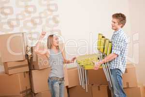 Moving house: Man and woman with box and chair