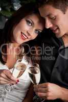 Portrait of extravagant man and woman with champagne