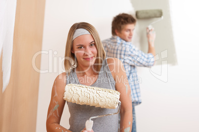 Home improvement: Young man and woman painting wall