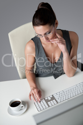 Successful business woman at office having coffee