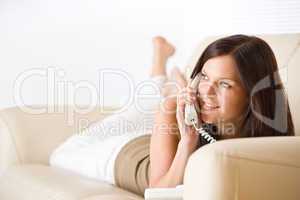 On the phone: young woman calling in lounge