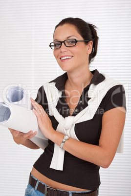 Smiling female architect holding plans