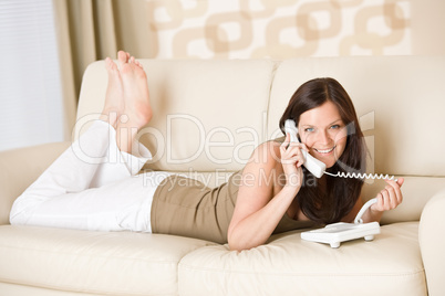 On the phone: young woman calling in lounge