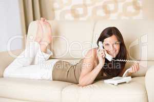 On the phone: young woman calling in lounge