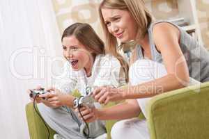 Students - Two happy female teenager playing TV game