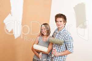 Home improvement: Young man and woman painting wall