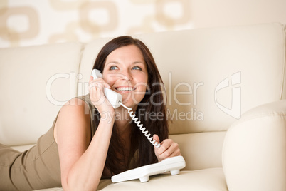 On the phone: young woman calling in lounge