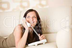 On the phone: young woman calling in lounge