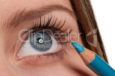 Blue eye, woman applying turqouise make-up pencil