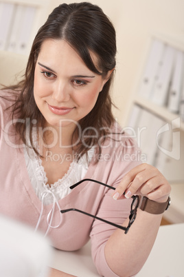 Happy businesswoman sitting at office desk