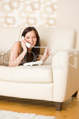 On the phone: young woman calling in lounge