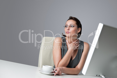 Thoughtful business woman at office with coffee