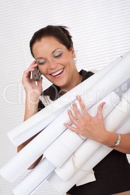 Young attractive female architect holding plans and telephone