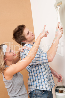 Home improvement: Man painting wall with paintbrush