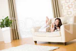 On the phone: young woman calling in lounge