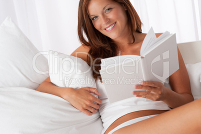 White lounge - Smiling woman holding white book