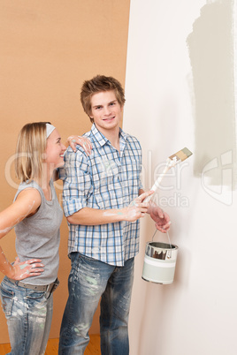 Home improvement: Man painting wall with paintbrush