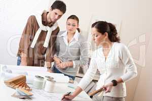 Female interior designer with two clients at office