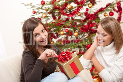 Two women unpacking Christmas present