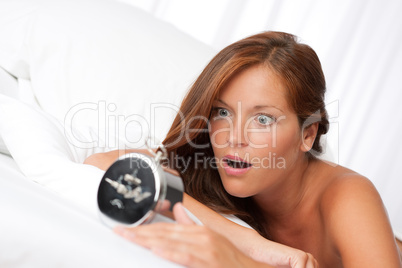 White lounge - Shocked woman with alarm clock