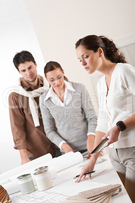 Female interior designer with two clients at office