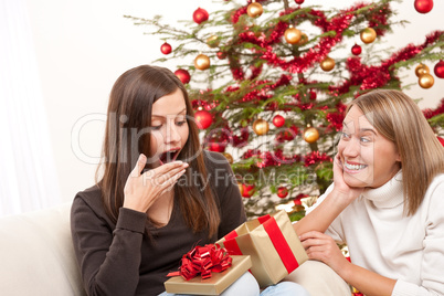 Two women unpacking Christmas present