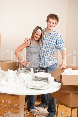 Moving house: Happy man and woman with box