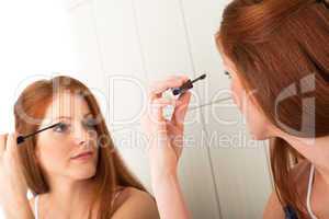 Body care series - Beautiful young woman applying mascara
