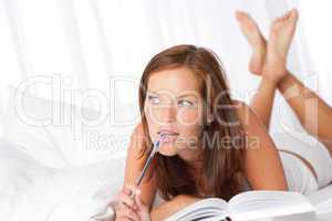 White lounge - Woman with pen and book thinking