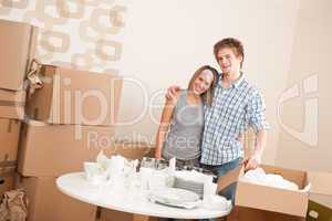 Moving house: Happy man and woman with box