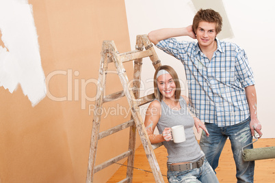 Home improvement: Young couple painting wall