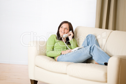 On the phone home: Smiling woman calling