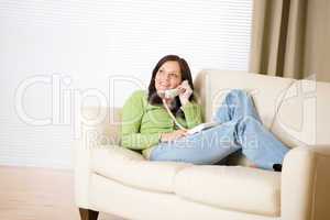 On the phone home: Smiling woman calling